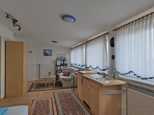 Blick zu Kleiderschrank und Sofa - Etagenwohnung mit 35,00 m² in Baunatal zur Miete