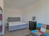 breites Bett hinter dem Raumteiler - 