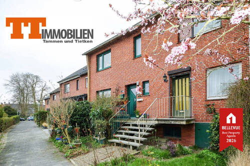 Außenansicht - TT bietet an: Charmantes Reihenmittelhaus mit hübscher Hochterrasse in ruhiger Lage von Wilhelmshaven-Neuengroden!