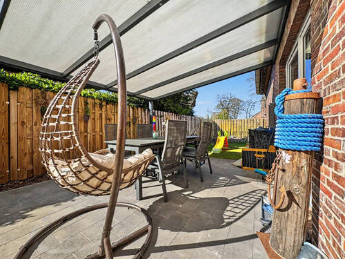 Gartenansicht mit Terrassenüberdachung - Einfamilienhaus mit 132,00 m&sup2; in Apen / Augustfehn zum Kaufen