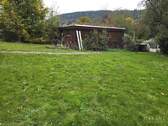 Doppelgarage mit Holzplatz - 