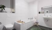 Ein modern gefliestes Badezimmer, inklusive Badewanne - 