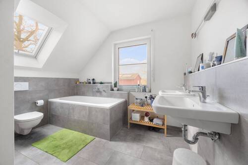 Dusch- und Wannenbad in grauem Design und hochwertigen Sanitärobjekten - 