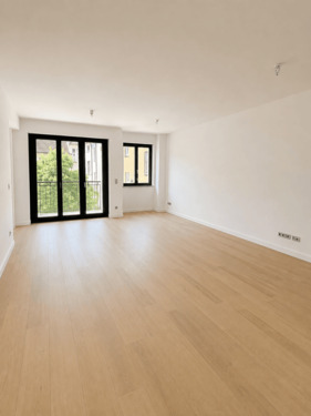 Wohnzimmer - BOXI 12 - Höchster Wohnkomfort: 3 Zimmer, 2 Bäder, 2 Balkone und Aufzug direkt in die Wohnung