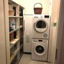 Wirtschaftsraum mit Waschmachine, Waschtrockner, Regalen - 