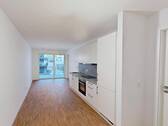 Muster I: Wohn- und Esszimmer mit offenem Küchenbereich - Lichtdurchflutete 2-Zimmer-Neubauwohnung mit Einbauküche und Balkon!