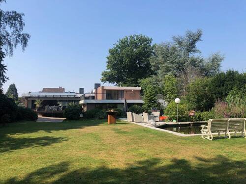 Rückwärtige Hausansicht mit überdachter Terrasse und Garten - Bungalow mit 400,00 m&sup2; in Uetersen zum Kaufen