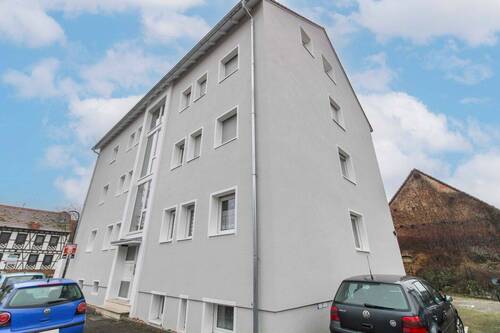 Seitenansicht - 2 Zimmer Mehrfamilienhaus, Wohnhaus zum Kaufen in Karben
