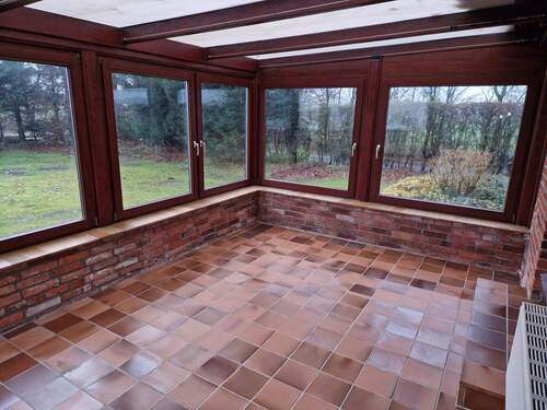 Wintergarten mit Ausblick in den gepflegten Garten - 