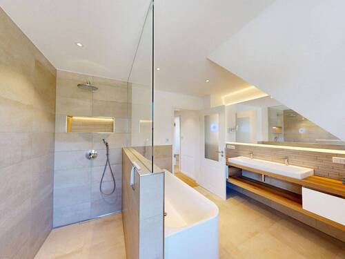 aufwendig gestalteter Badezimmerbereich mit Badewanne und Dusche - 