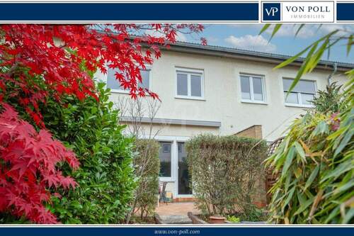 Hausansicht Garten - Charmantes Reihenmittelhaus mit Garten, Garage und sonniger Terrasse