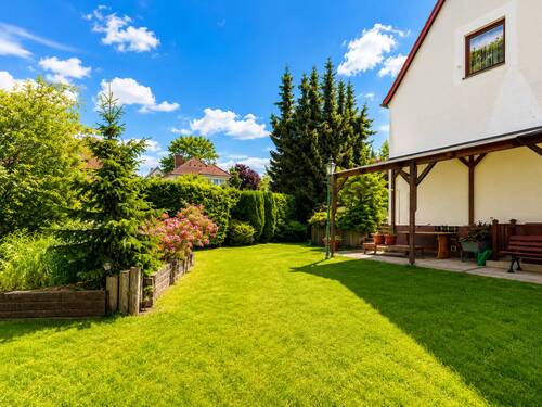 Weitere Gartenansicht mit Rasenfläche, Terrasse und gewachsener Begrünung.png - 