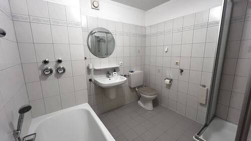 Badezimmer mit Badewanne und Dusche - 