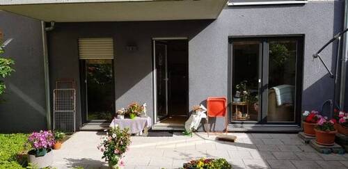 Terrasse mit Türen zu Wohnbereich und Schlafzimmer - Erdgeschosskomfortwohnung mit Privatgarten