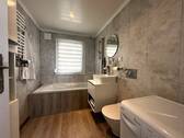 Badezimmer mit Badewanne, Fenster, WM-Anschluss und WC - 