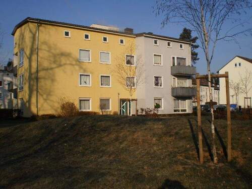 Außenansicht des dreistöckigen Mehrfamilienhauses mit Grünflächen im Vordergrund - Etagenwohnung mit 64,10 m&sup2; in Stadtallendorf zur Miete