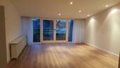 Wohnzimmer mit Loftcharakter und offenem Kamin - Etagenwohnung mit 148,00 m&sup2; in Meerbusch zur Miete