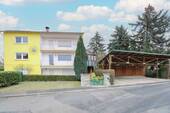 Straßenansicht mit Carport - Die Sonne genießen: ETW mit Garten und Carport