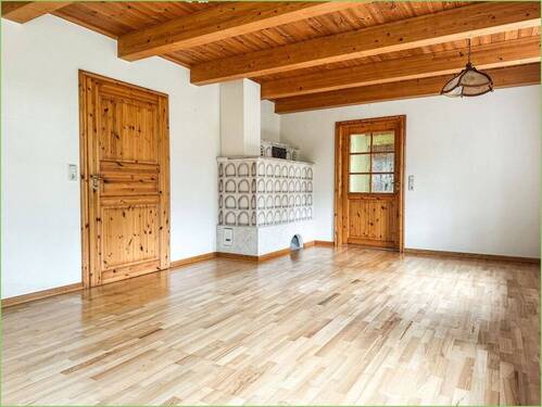 Wohnbereich mit Kachelofen - Einfamilienhaus mit 174,00 m² in Tetenbüll / Wasserkoog zum Kaufen