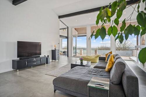 Wohnbereich mit bodentiefen Fenstern und gigantischem Panoramablick - 