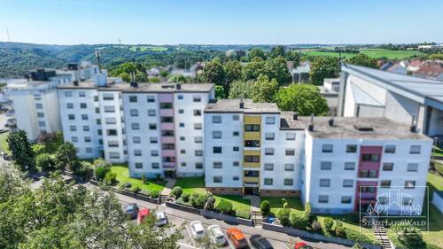 Hausansicht mit Parkplätzen und Umgebung - 