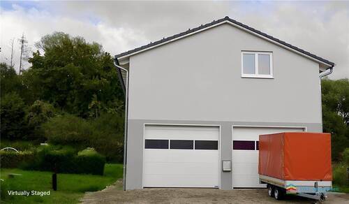 Frontaufnahme mit Rolltoren - virtually staged - Einfamilienhaus mit 229,60 m&sup2; in Radolfzell am Bodensee zum Kaufen