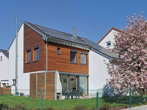 Hausansicht mit Garten und Solarpanel von der Straße - Sanierte Rarität mit Loft-Charakter: Exklusives Einfamilienhaus im KfW 70 Standard in Bestlage
