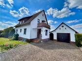 Ansicht auf das Wohnhaus, die Garage und die Einfahrt - Großzügiges EFH mit Einliegerwohnung, Garten & vielseitigen Nutzungsmöglichkeiten in Oldenstadt