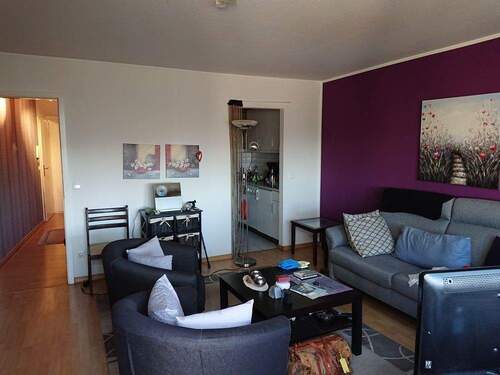 Wohnzimmer mit Blick in Küche und Flur - 