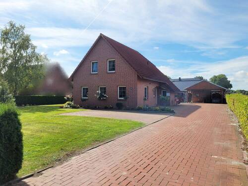 Ansicht Hauseinfahrt - Einfamilienhaus mit 125,00 m² in Filsum zum Kaufen