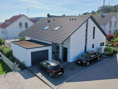 Hausansicht von der Straße mit Garage und Stellplätzen - 