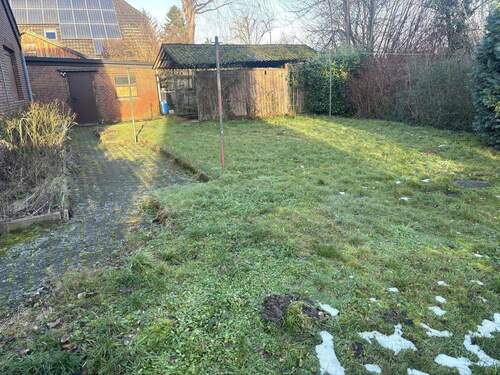 Garten mit Blick auf die Garage und Carport - 