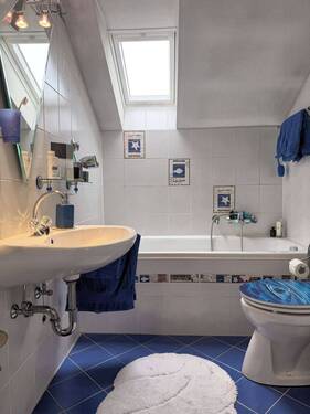Gefliestes Badezimmer mit Dachfenster - 