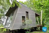 Seitenansicht - Architektonisch beeindruckendes Tiny House auf großzügigem Baugrundstück für Ihr Einfamilienhaus