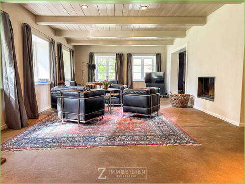 Wohnbereich mit Kamin - Mehrfamilienhaus, Wohnhaus mit 407,00 m² in Garding Kirchspiel zum Kaufen