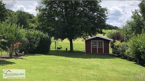 Garten mit zwei Gästen im Hintergrund - Einfamilienhaus mit 141,00 m² in Perl zum Kaufen