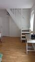 Wohnzimmer mit Treppe zum Dachgeschoss (3. OG) - 4 Zimmer Etagenwohnung in Berlin