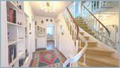 Heller Eingangsbereich mit geschwungener Treppe - 