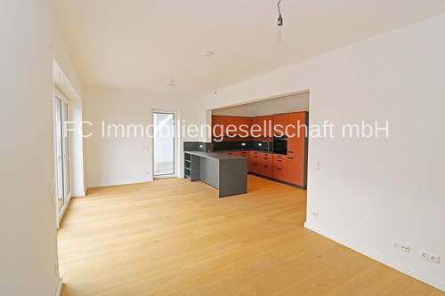 Wohnzimmer mit Blick in die offene Küche im EG - 