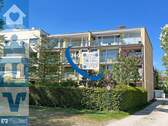 Außenansicht des Mehrfamilienhauses in Laim - Vielseitige 3,5-Zi.-DG-Wohnung mit Renovierungsbedarf und zwei Balkonen