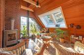 Wohnbereich im Obergeschoss mit Kamin und Dachfenster - 