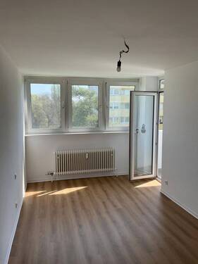 Wohnzimmer mit neuem Bodenbelag in Holzoptik, Wände in weiß angelegt - 