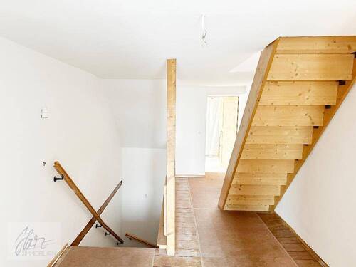 Flurbereich mit Blick zur Treppe Richtung Wohnungseingangstür nach unten und Treppe zum oberen Wohnbereich - 