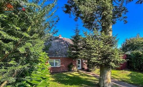 Hausansicht 1 - Pferdeliebhaber aufgepasst! Großes Einfamilienhaus mit Nebengebäuden und viel Land in Spieka