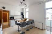 Küchenbereich mit Theke und Zugang zum Balkon - 2 Zimmer Etagenwohnung zum Kaufen in Düsseldorf
