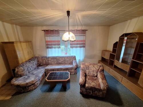 Wohnzimmer mit Kamin - Einfamilienhaus mit 68,00 m&sup2; in Friedland zum Kaufen