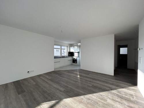 Wohn- und Essbereich - Lichtdurchflutete 3,5 Zimmer-Neubauwohnung mit Einbauküche zu vermieten!
