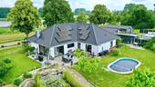 Objektansicht - Zukunftssicher und energieeffizient: Premium-Immobilie mit Seeblick und Pool