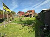 Gartenansicht - Mehrfamilienhaus, Wohnhaus mit 106,80 m² in Rhauderfehn zum Kaufen