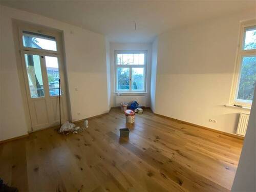 Blick ins Wohnzimmer mit Balkonzugang und offener - 